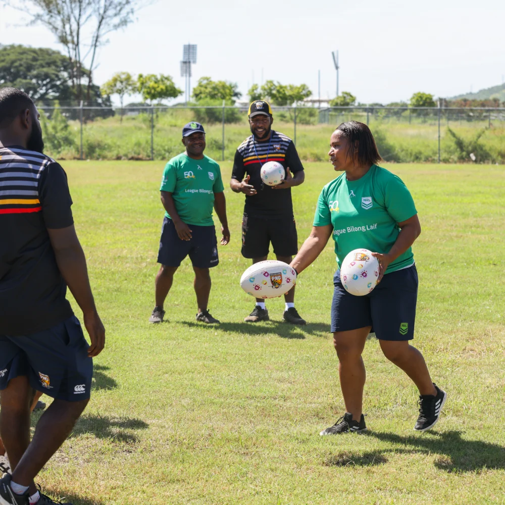 Coaches running a League Bilong Laif development session